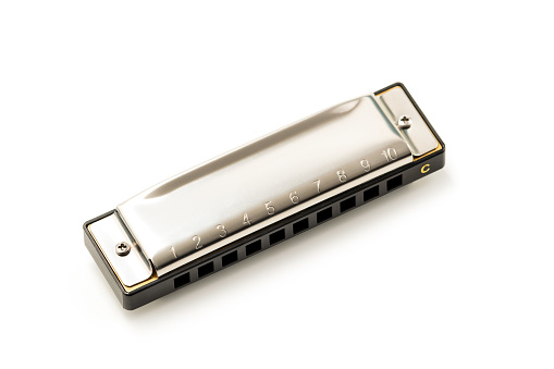 Harmonica, also French harp, blues harp, and mouth organ, isolated on white background with clipping \n\npath included. Free reed wind instrument used worldwide in blues, American folk, jazz, rock and roll.