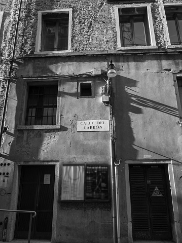 Black and white photo of the facade of a building in Venice, Italy.
