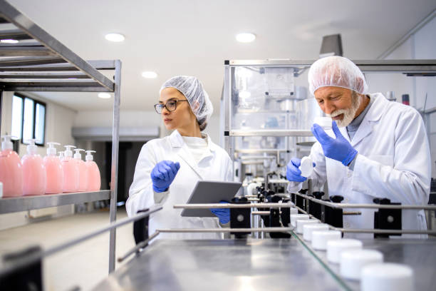 istock Experienced pharmaceutical workers testing quality and smell of anti-aging cream inside cosmetic factory. 1469919291