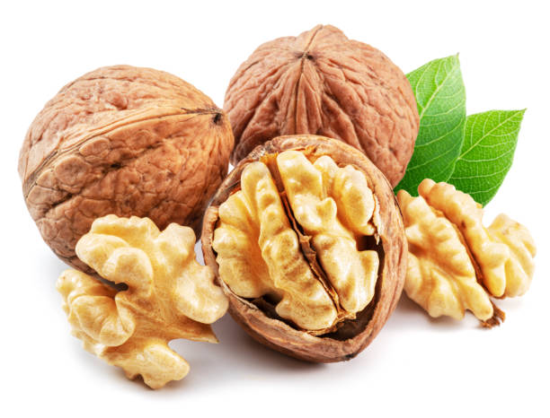 istock Whole walnut and walnut kernels with leaves isolated on white background. 1469922959