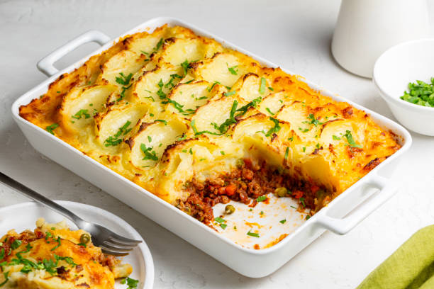 istock English Shepherd's pie, or cottage pie, or French version hachis Parmentier. Cooked minced beef meat with vegetables topped with mashed potato and baked. 1469923028