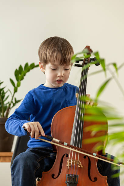 istock White 5 year old boy learning to play the cello 1469923792