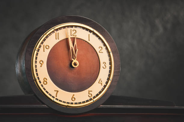 istock Close-up of a table vintage round clock from a low angle. Five minutes to twelve. 1469924341