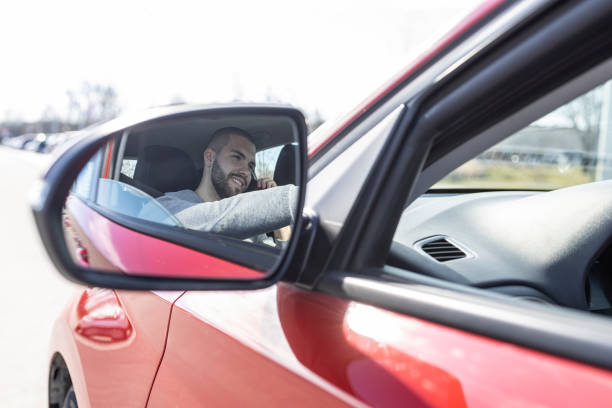 istock Man talking on the phone while driving his car. 1469927598