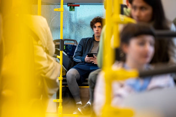 istock Young adult man riding bus and using mobile phone 1469929217