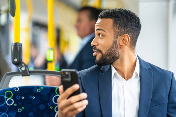 businessman riding bus and talking on video conference - bus riding public transportation businessman imagens e fotografias de stock