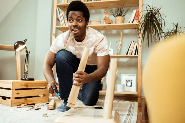 istock Happy young African man making some home repairs 1469929826