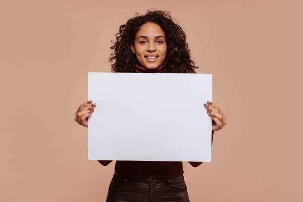 Young smiling woman holding blank banner