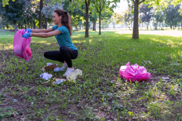 istock A young woman in blue collecting trash from forest 1469937618