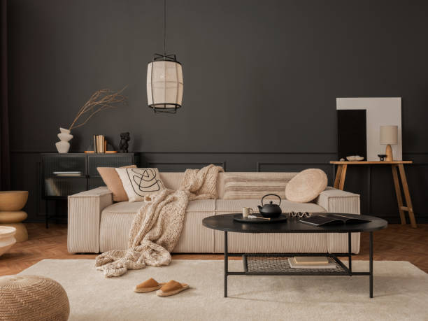 istock Elegant living room interior with mock up poster frame, modular sofa, black coffee table, rug, pouf, lamp, pillows, wooden bench, vase with dried flowers and personal accessories. Home decor. Template. 1469939364