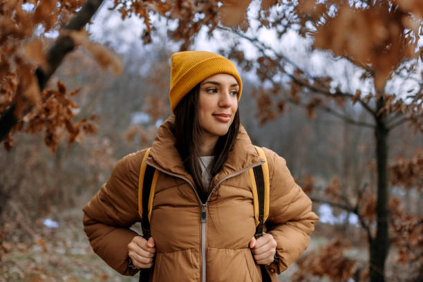 istock Young beautiful woman enjoys hiking in forest 1469940107