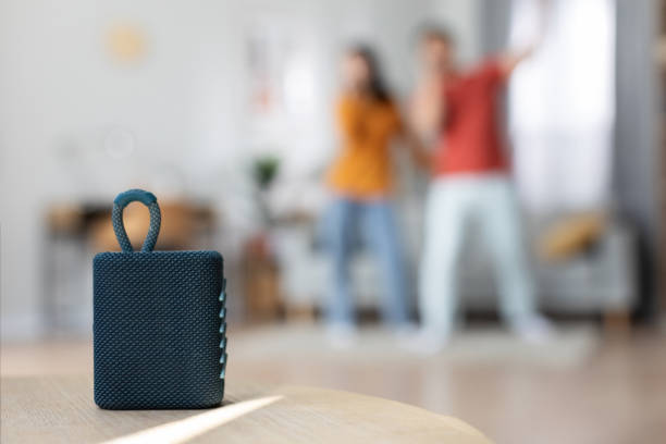 istock Selective focus on brand new portable speaker over singing couple 1469940713