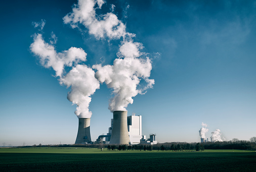 High resolution photograph of a modern brown-coal fired power plant with pollution.