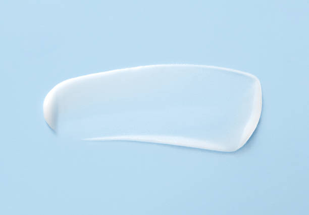 cosmetic smears cream texture on pastel blue background