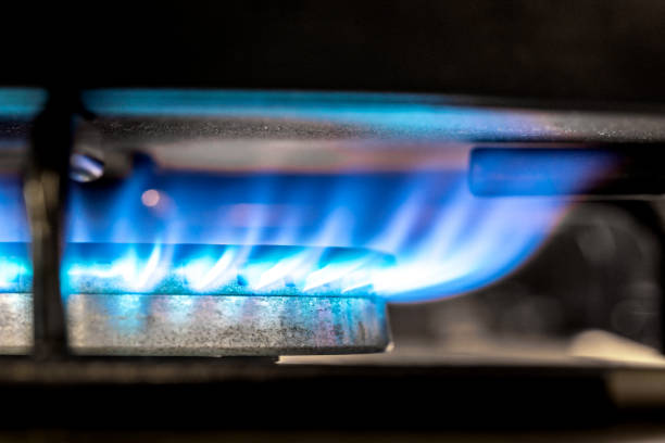 A close-up showing the ignited flames of a domestic gas boiler.