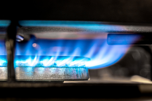 Burning gas burner extreme close-up on dark background