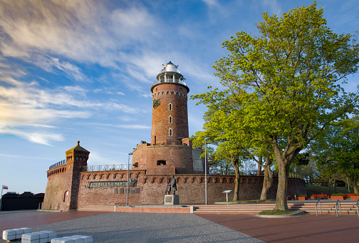 Lighthouse tower in Kolobrzeg city park, Baltic Sea coast, Poland. Sunset