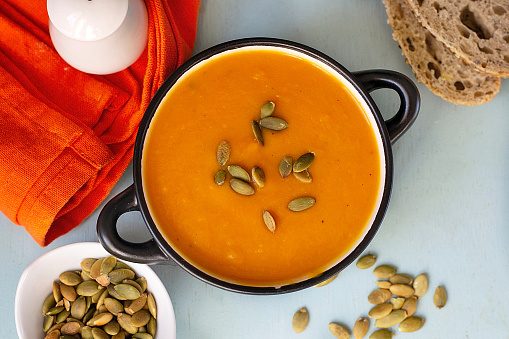 Healthy pumpkin cream soup with vegetables and pumpkin seeds