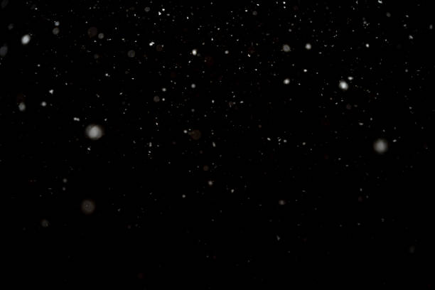 istock Snowfall isolated on black background. Abstract white bokeh background. 1469950124
