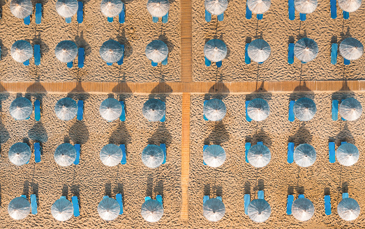 Aerial view on blue sunbeds on a sandy beach in Greece (Vai, Crete).