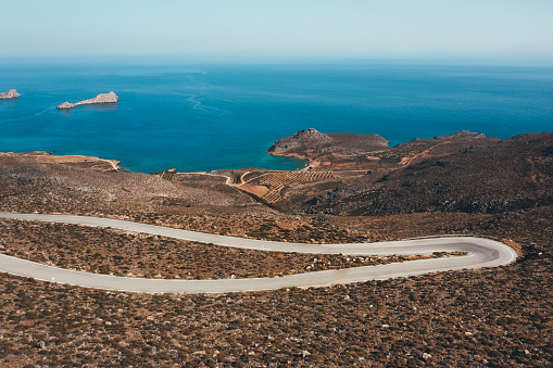 Aerial view on winding mountain road towards Xerokampos (Crete, Greece).
