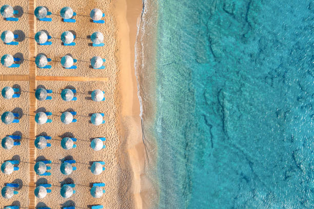 Aerial View On A Sandy Beach Aerial view on famous Vai beach with palm trees (Lasithi, East Crete, Greece). beach umbrella aerial stock pictures, royalty-free photos & images