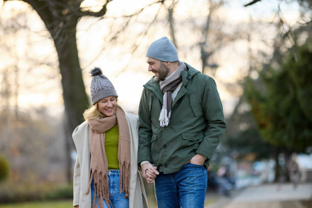 istock Romantic couple enjoying a walk in the park holding hands 1469950400