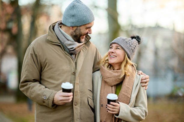istock A happy romantic couple with coffee walking in the park 1469952012