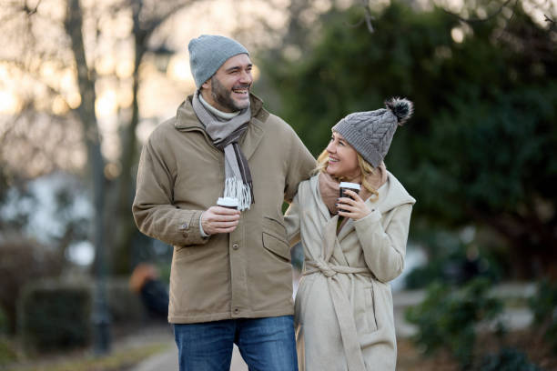 istock A happy romantic couple with coffee walking in the park 1469952045