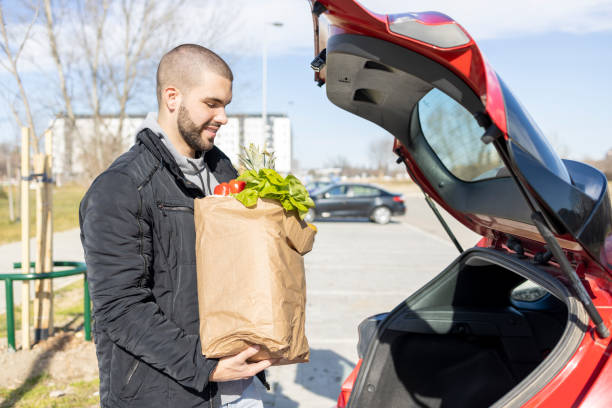 istock Smiling man with bag full of groceries 1469952608