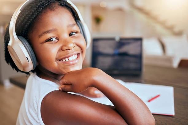 istock Education, homework and African girl with music for learning studying and elearning with school books in house. Podcast, happy and portrait of a young child with headphones during study for knowledge 1469952912