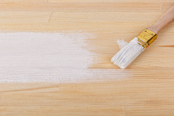 istock white paint with a brush on a wooden background with texture 1469954717