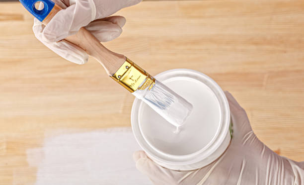 istock white paint with a brush painting a wooden background with texture 1469954741