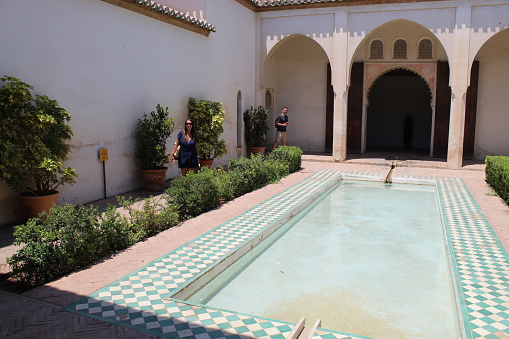 Image of a beautiful courtyard with a fountain in the Alcazaba of Málaga. Image taken in July 2022.
