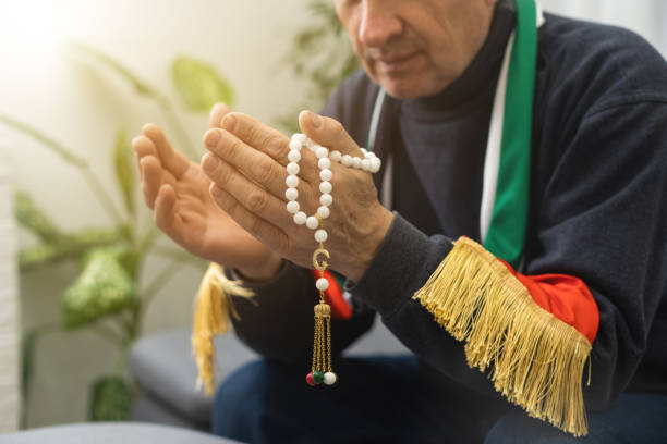 istock Praying hands of an old man holding rosary beads. 1469956797