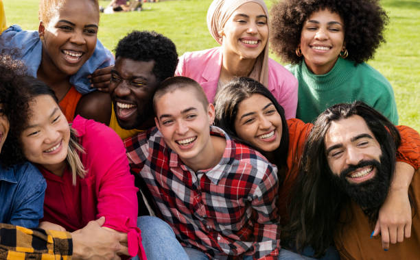 istock group of multiracial people having fun outdoors. diverse people hugging and enjoying the holidays. 1469956898