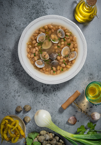 Pochas Fabes con Almejas from Asturias in Spain white beans traditional stew with clams, Mediterranean food