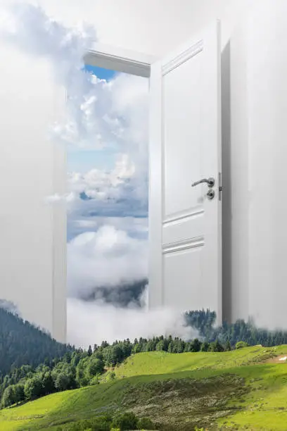 Photo of A white door opening to another world. The Door Between Worlds