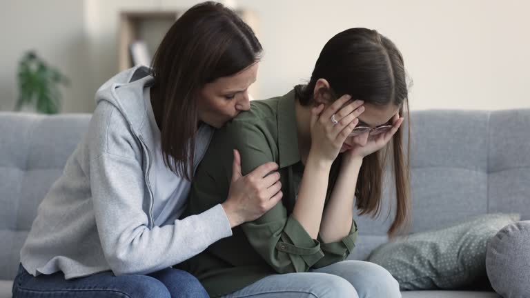 Loving concerned mum consoles upset teenager daughter