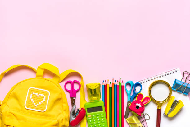 istock Back to school, education concept Yellow backpack with school supplies - notebook, pens, eraser rainbow isolated on pink background Top view Copy space Flat lay composition Banner 1469963192