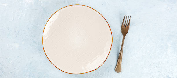 istock A white plate with a fork panorama, overhead flat lay shot, a panoramic banner 1469963579