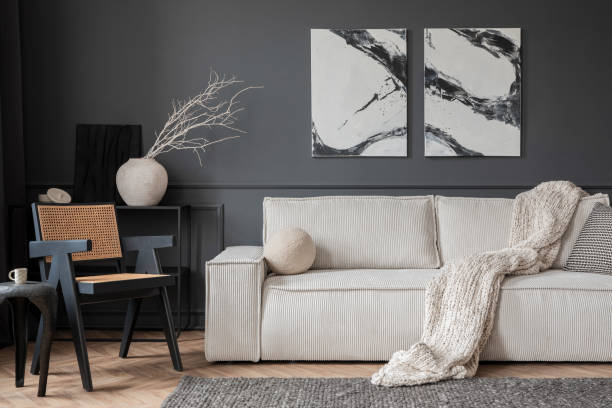 istock Modern composition of living room interior with mock up poster frame, modular sofa, black consola, beige plaid, round pillow, rattan armchair and personal accessories. Home decor. Template. 1469964053