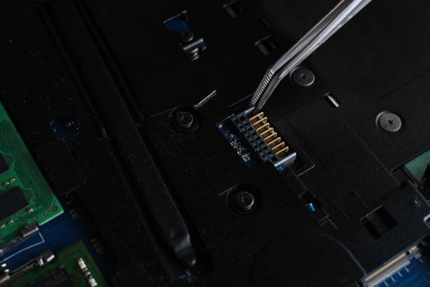 istock master repairs laptop and system board close-up 1469964772
