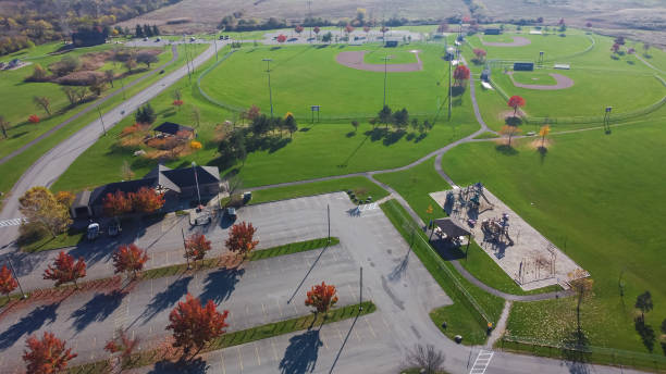 istock Grassy baseball fields near empty parking lots colorful fall foliage at community recreational center in Rochester, Upstate New York 1469964852