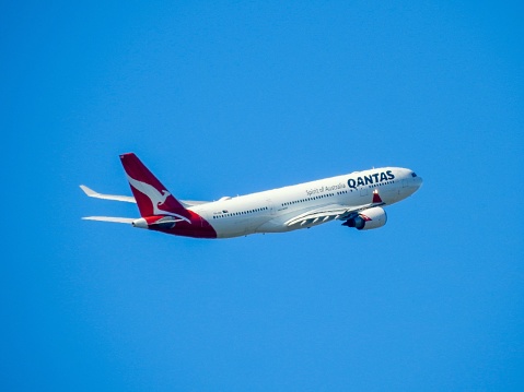 A Qantas Airbus A330-202, VH-EBB, flight number QF463, has taken off to the north from the third runway of Sydney Kingsford-Smith Airport and heading to Melbourne.  This image was taken from Shep's Mound, a public viewing area off Ross Smith Avenue, on a sunny afternoon on 26 February 2023.
