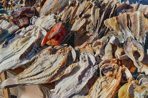 Traditional fish-drying on the beach of Nazare, Portugal. Authentic Portuguese cuisine, local business.