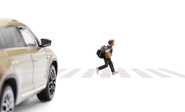 istock Boy running at a pedestiran crossing and car approaching 1469966862