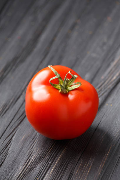istock fresh tomato on a dark wooden background 1469967419