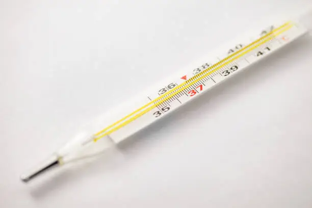 Photo of Thermometer mercury for measuring human body temperature, close-up part selective focus