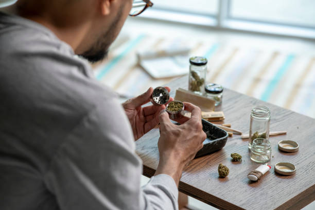 istock Young Asian man preparing marijuana at home. 1469968302